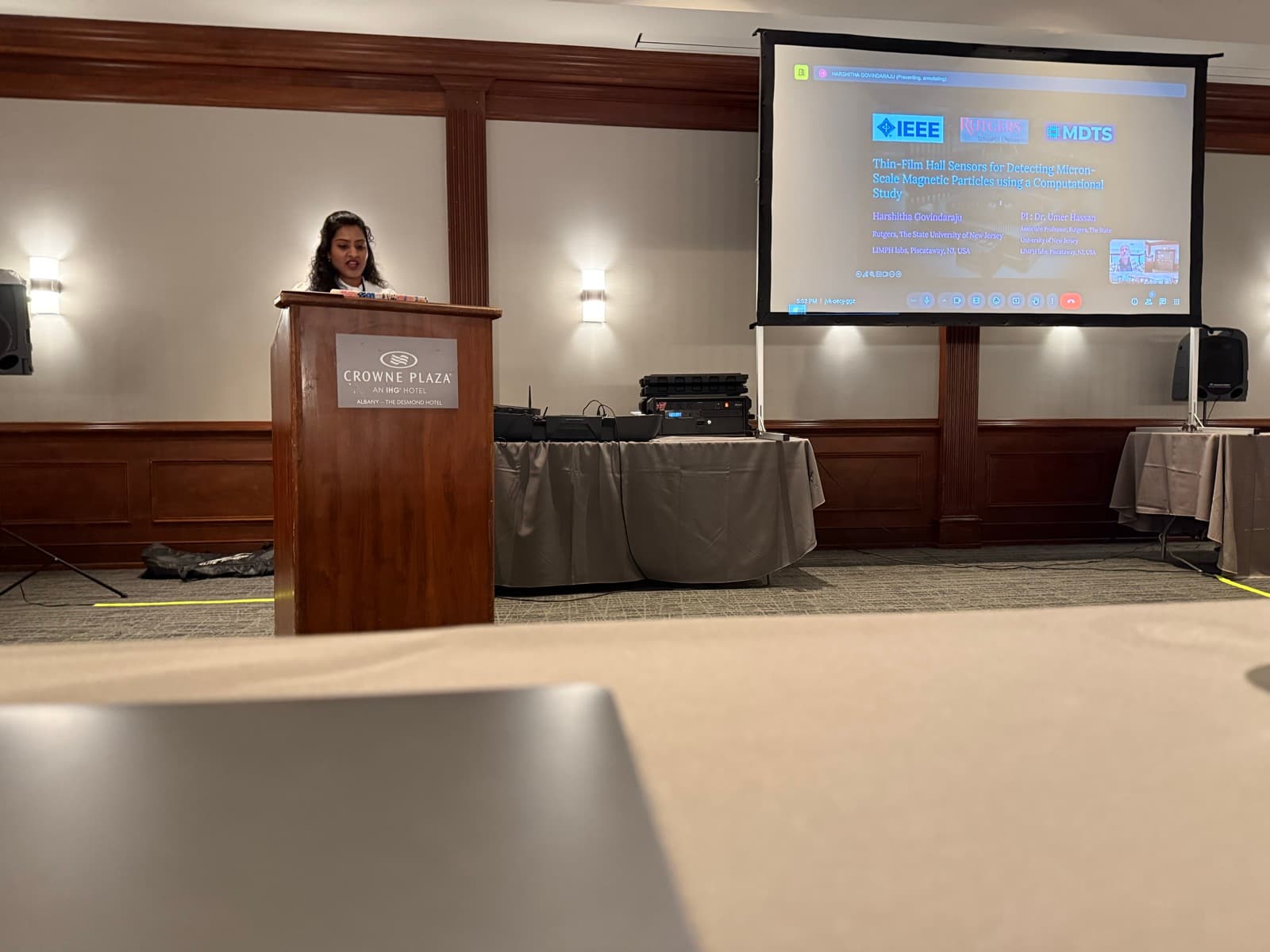Harshitha presenting 'Thin-Film Hall Sensors for Detecting Micron-Scale Magnetic Particles' at an IEEE MDTS conference session.